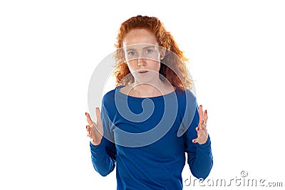 Indoor shot of stressed and annoyed young redhead Caucasian woman with curly hair holding hands in mad furious gesture, screaming Stock Photo