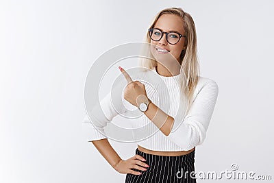 Indoor shot of successful good-looking energized creative female entrepreneur with fair hair in glasses and watch Stock Photo