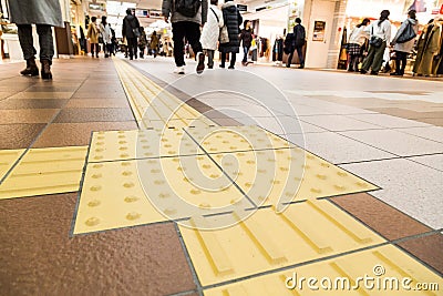 Indoor tactile paving foot path for blind and vision handicap Stock Photo