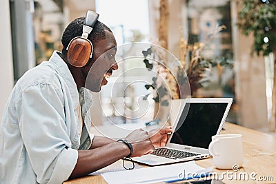 Technology man male headphones office young handsome communication computer work laptop earphones Stock Photo
