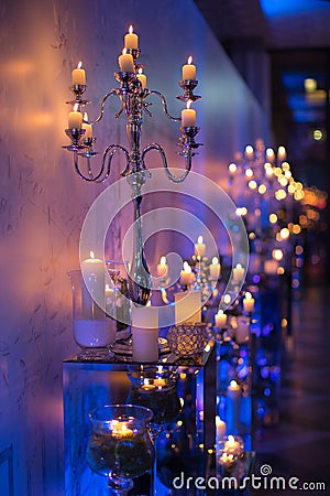 Indoors wedding decoration in the evening with candles and fir b Stock Photo