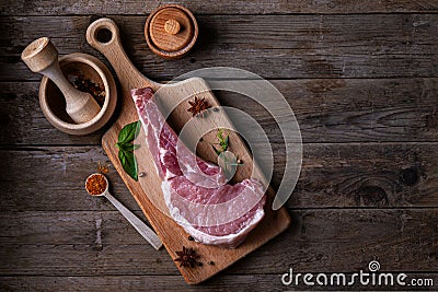 Indulge in the rustic charm of a raw piece of pork loin on a wooden board Stock Photo