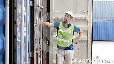 Industrail background of caucasian containers yard and cargo inspector working at containers loading area Stock Photo