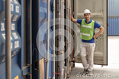 Industrail background of caucasian containers yard and cargo inspector working at containers loading area Stock Photo