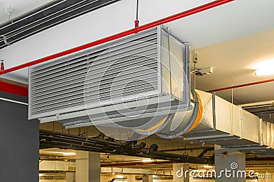 Industrial air duct ventilation equipment and pipe systems installed on industrial building ceiling. Stock Photo