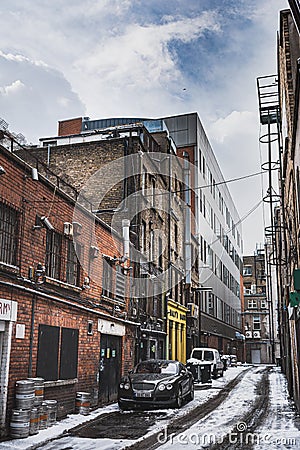 Irish architecture and industrial style: a narrow alley highlights how a modern office stands beside an old building. Dublin Editorial Stock Photo