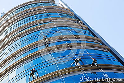 Industrial alpinists cleaning skyscraper Stock Photo