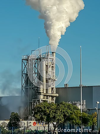 Industrial chimney expelling a lot of smoke Editorial Stock Photo