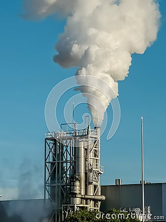 Industrial chimney expelling a lot of smoke Stock Photo