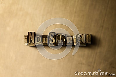 INDUSTRIAL - close-up of grungy vintage typeset word on metal backdrop Cartoon Illustration