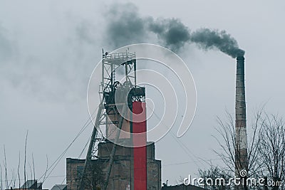 Industrial coal mine billowing black smoke into skies. Stop pollution. Industrial chimney Stock Photo