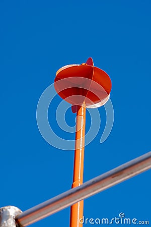 Industrial, complex shape, metal, orange sea buoy. An metal pipe in foreground Stock Photo