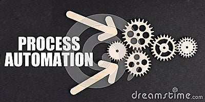 On the black surface, arrows, gears and an inscription - PROCESS AUTOMATION Stock Photo