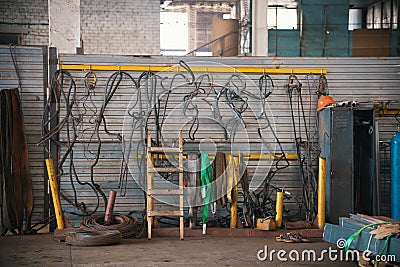 Industrial concept. Constructing lifting crane in the plant. Metal cables on the wall Stock Photo