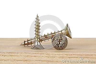 Industrial concept - screws screwed into wood plank, white background Stock Photo