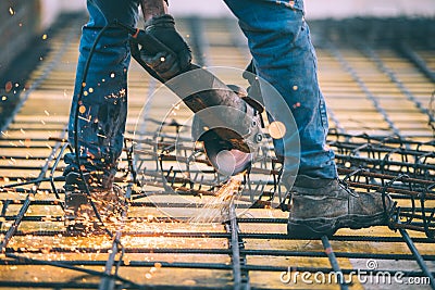 Industrial construction engineer cutting steel using angle mitre saw, grinder and tools Stock Photo