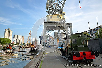 Industrial cranes, boats and an old locomotive located at Leuvehaven Harbor, Rotterdam, Netherlands Stock Photo