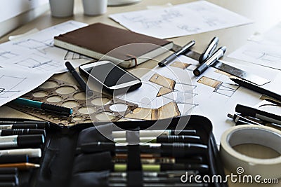 Industrial designers desk with drawing instruments and design sketches Stock Photo