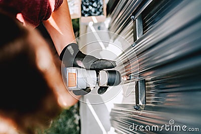 Industrial details of working construction man, using screwdriver Stock Photo