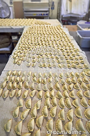 Industrial dumplings production before cooking. Stock Photo