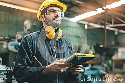 Industrial Engineers in Hard Hats.Work at the Heavy Industry Manufacturing Factory.industrial worker indoors in factory. man Stock Photo