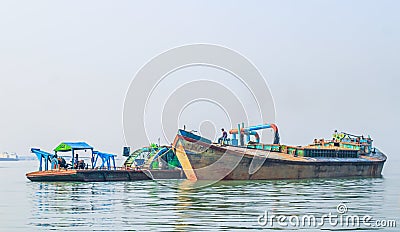 The industrial extraction of sand for construction. The pipe abrasives sand with water under strong pressure. Stock Photo