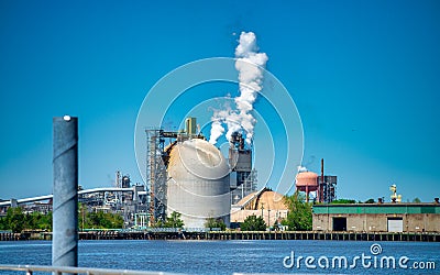 Industrial facility. Exterior of modern petrochemical plant with reactors and converters. Smoke from the chimney Stock Photo