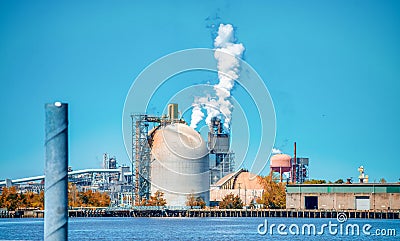 Industrial facility. Exterior of modern petrochemical plant with reactors and converters. Smoke from the chimney Stock Photo