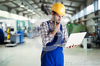 Industrial factory employee working in metal manufacturing industry Stock Photo