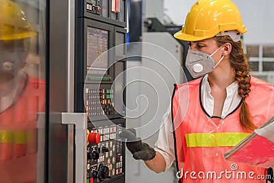 Industrial or factory engineering worker and supervisor setting up computerized control panel of factory assembly line controller Stock Photo