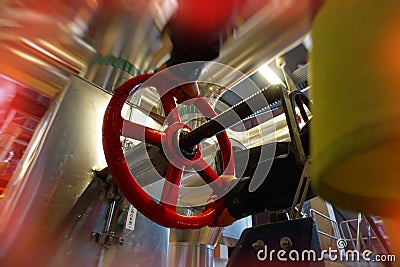 Industrial factory worker turning red wheel of valve Stock Photo