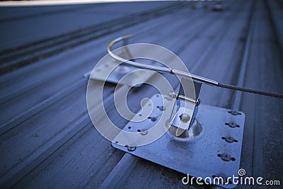 industrial fall arrest fixed safety line roof anchor point corner systems on top of construction Stock Photo