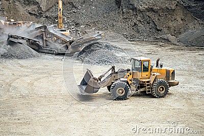 Industrial heavy duty bulldozer moving gravel on construction site Stock Photo