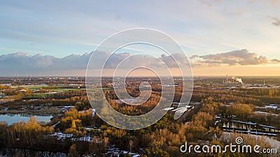 Industrial Horizon Beyond the Green Expanse Stock Photo