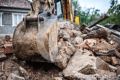 Industrial hydraulic backhoe bulldozer loading demolition debris Stock Photo