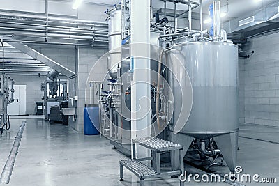 Industrial interior of beverage factory, blue toned. Food and drink production manufacturing Stock Photo