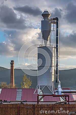 Industrial landscape Sawmill with a metal silo Stock Photo