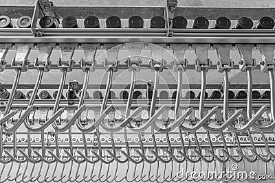 Industrial loading dock area inside cold storage warehouse. Meat hanging hooks hanging on the rail system Stock Photo