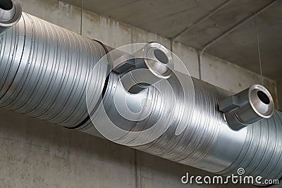 Stainless steel ventilation system in a loft room. Stock Photo
