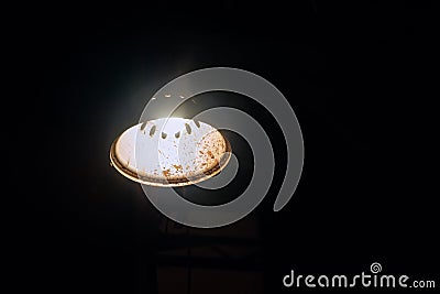 Industrial metallic ceiling lighting lamp light in the darkness Stock Photo