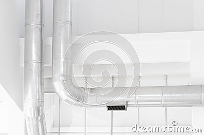 Interior in light tones: white walls and silver pipes Stock Photo