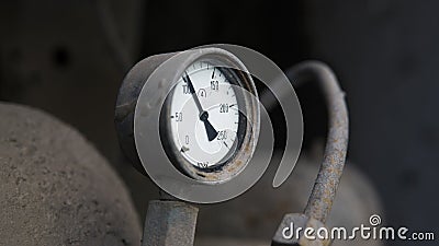 Industrial old white vintage barometer with old dirty gas cylinder. Stock Photo