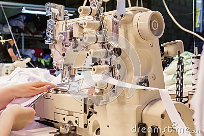 Industrial overlock sewing machine in work Stock Photo