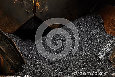 Industrial pavement machine laying fresh asphalt on road construction. Stock Photo