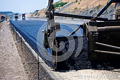 Industrial pavement truck laying fresh asphalt Stock Photo