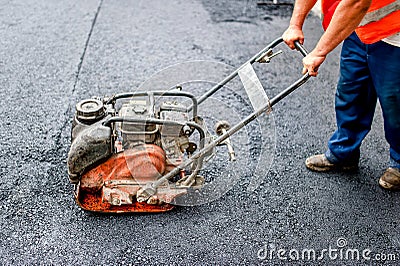 Industrial pavement truck or machine laying fresh bitumen Stock Photo