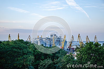 Industrial plant metal containers and cranes in the infrastructure of the city Stock Photo