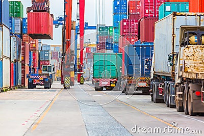 Industrial port crane lift up loading export containers box onboard. Stock Photo