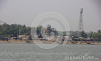 Industrial riverbank with factories and electrical pole. Riverbank full of concrete pillars. Beautiful southeast Asian river and Stock Photo