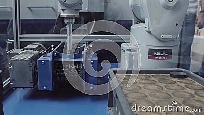 Industrial robot with conveyor in manufacture factory,Smart factory industry. Robot for distribution metal products Editorial Stock Photo